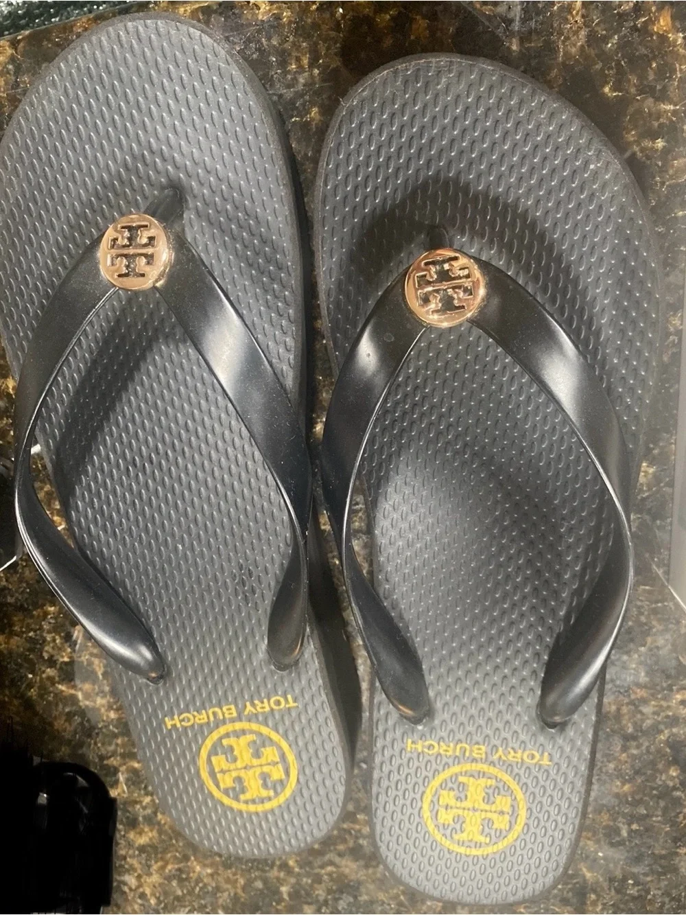 Tory Burch Black Flip Flop Sandals with Gold Logo Medallion